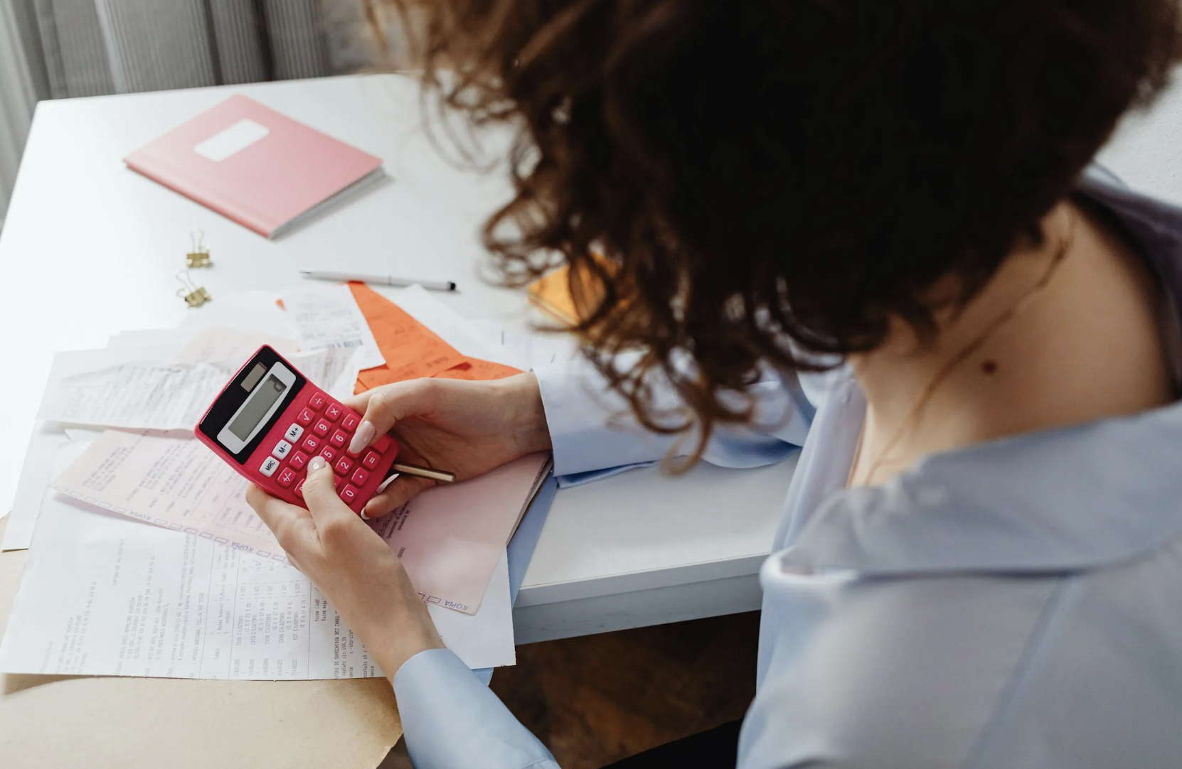 Woman Holding a Pink Calculator